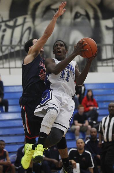 Basic’s Josh Villaros (11) goes up for a shot against Liberty’s Ryan Taggert dur ...