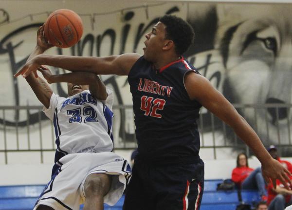 Basic’s Robert Sutton (32) is fouled by Liberty’s Noah Jefferson (42) during the ...