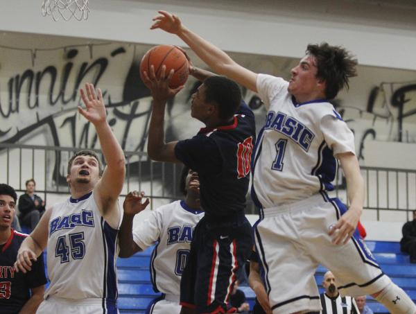 Liberty’s Jayven Hines-Stockton (10) attempts as shot as Basic’s Jared Meacham ( ...