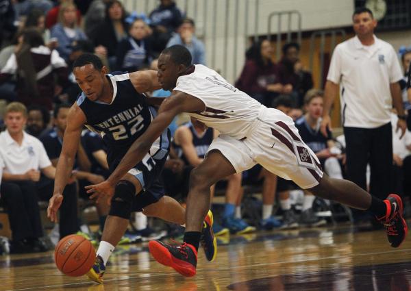 Centennial’s Aaron Turner (22) and Cimarron-Memorial’s Tony Harrison (11) battle ...