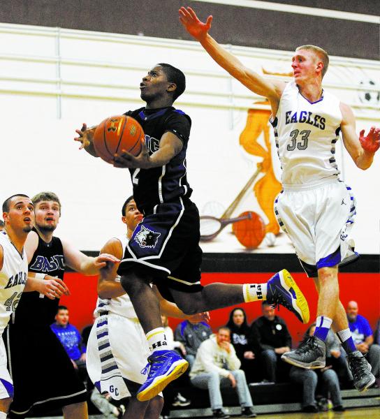 Basic’s Antraye Johnson (2) drives to the hoop past Graves County’s Eamon Hannon ...
