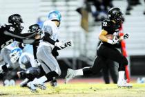Palo Verde’s Calvin Beaulieu (22) runs away from the Centennial defense.