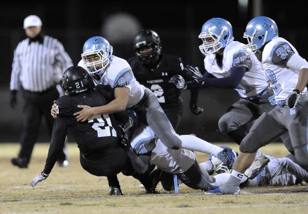 Centennial’s Dieyon Scott (28) wraps up Palo Verde’s Jaren Campbell.