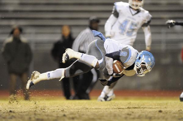 Centennial’s Gene Haley loses his balance while returning a kick.
