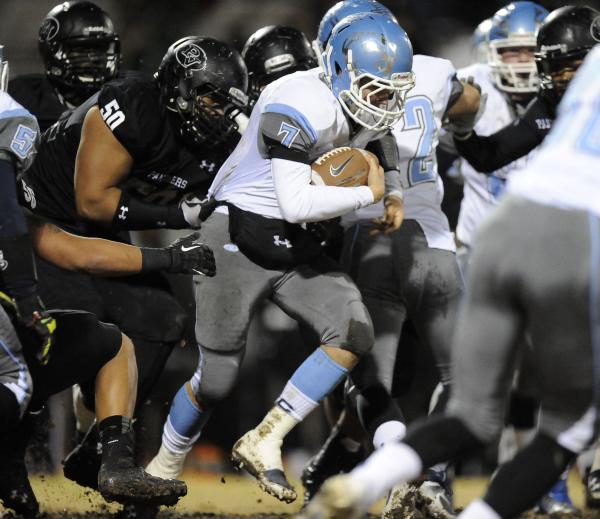 Centennial’s Coll Thomson (7) is grabbed from behind by Palo Verde’s Michael Hug ...
