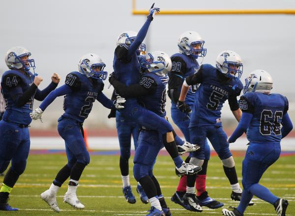 Pahranagat Valley’s Jake Carter lifts up teammate Shawn Wadsworth as the Panthers cele ...