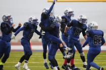 Pahranagat Valley’s Jake Carter lifts up teammate Shawn Wadsworth as the Panthers cele ...