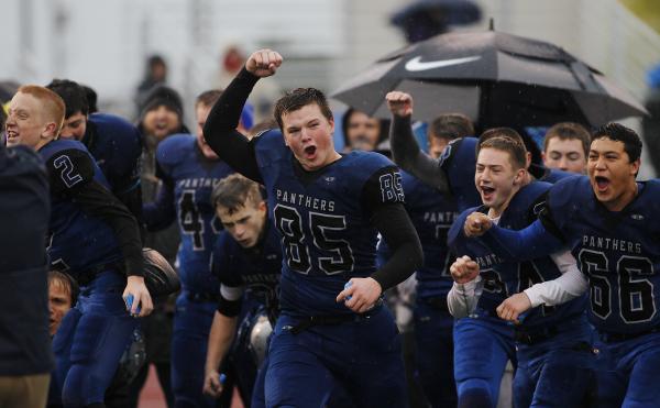 Pahranagat Valley’s Jake Carter (85) leads his team in celebration as the Panthers win ...