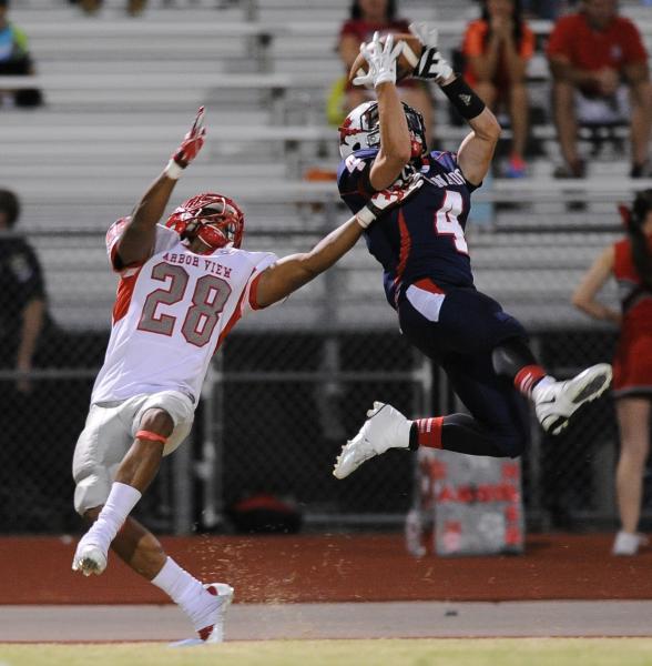Coronado receiver Michael Simpson (4) tries to make a leaping catch over Arbor View defender ...