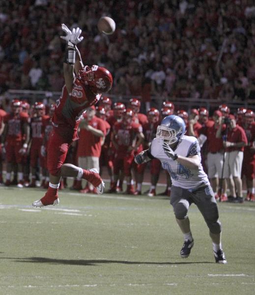 Arbor View running back Devon Turner leaps to try to catch a pass as Centennial’s Hunt ...