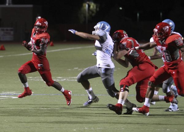 Arbor View running back Anthony Smith runs past Centennial linebacker Dieyon Scott in the se ...
