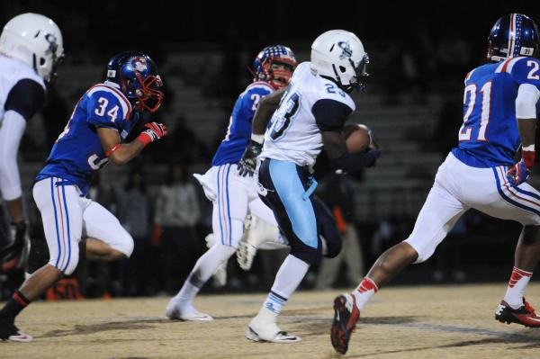 Canyon Springs running back Zaviontay Stevenson (23) breaks free from Liberty defenders on F ...