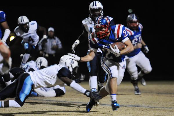 Liberty running back Tyler Parvin (23) breaks free from a Canyon Springs defender during the ...
