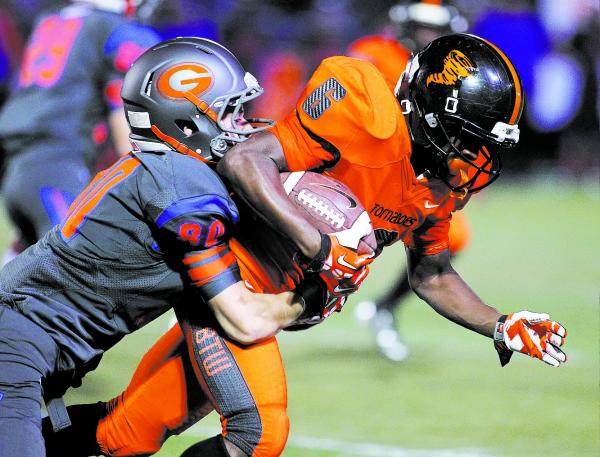 Bishop Gorman’s Karl Regan (80) tackles Booker T. Washington’s Shaquille Green ( ...