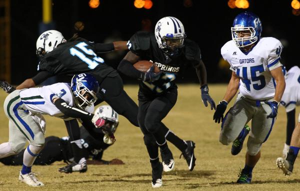 Canyon Springs’ Zaviontay Stevenson looks for running room as Green Valley’s Ant ...