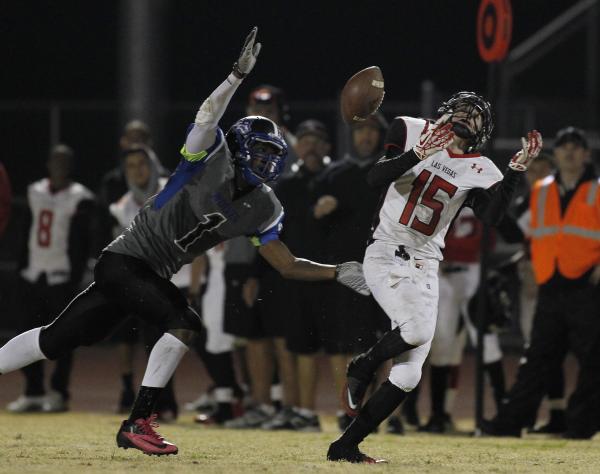 Las Vegas’ Sam Blackburn (15) has a pass bounce off his shoulder pads while being cove ...