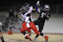 Las Vegas High wide receiver Aaron Zanin-Banks, front, returns a kick during the first quart ...