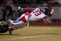 Liberty’s Brenan Adams (33) leans across the goal line to score in a 45-27 win over Co ...