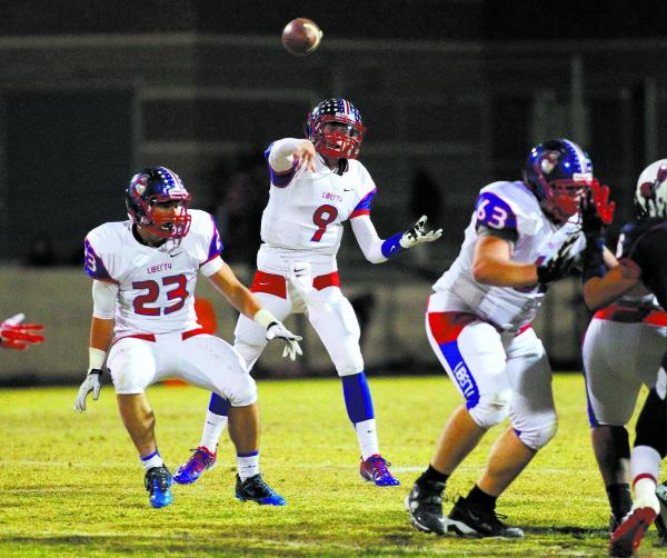 Liberty quarterback Tyler Newman (9) throws a pass in Liberty’s 45-27 victory over Cor ...