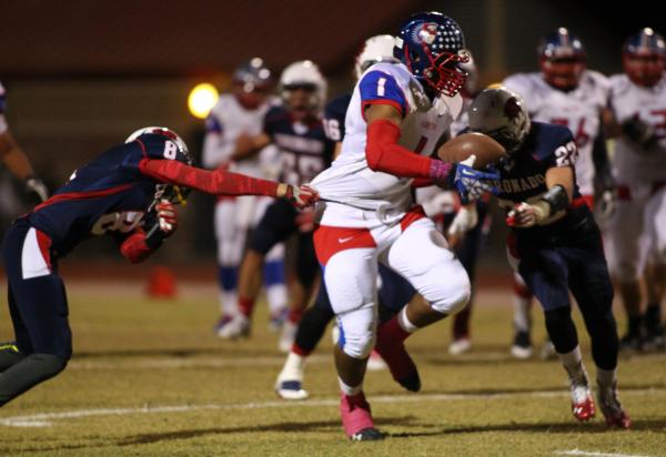 Liberty’s Stephon Sowers (1) powers past a Coronado defender on Friday.