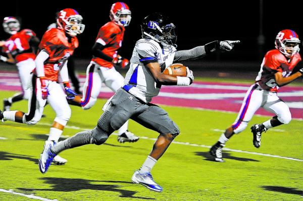 Desert Pines Tim Hough (4) points to the end zone as he scores on a 32-yard pass from Iquan ...