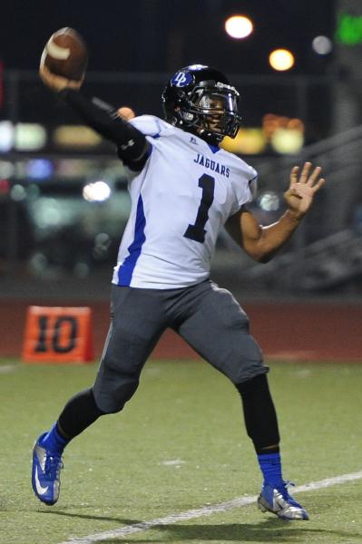 Desert Pines quarterback Iquan Corsey (1) throws a pass on Thursday at Valley. Corsey tossed ...
