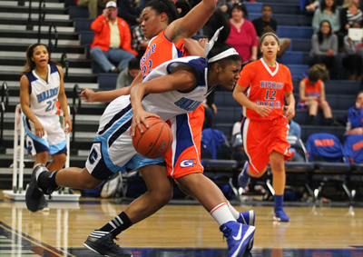 Centennial’s Jada Brown is fouled by Bishop Gorman’s Raychel Stanley during a ga ...