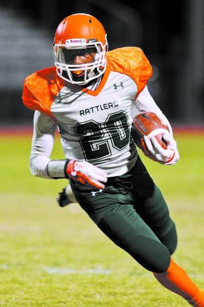 Mojave’s Eric Snyder (20) carries the ball on Friday against Faith Lutheran.