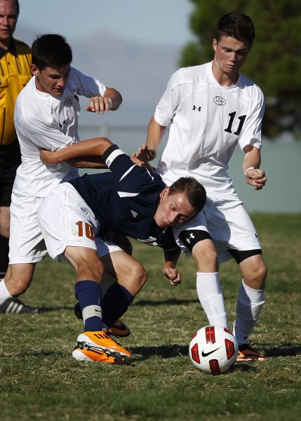 Legacy’s Luka Skrinjaric, center,  battles for the ball with Palo Verde’s M ...