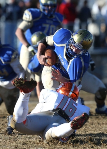 Bishop Gorman‘s Haskell Garrett sacks Reed quarterback Matt Denn in an NIAA Division I ...