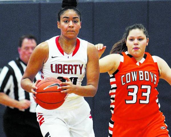 Liberty’s Paris Strawther (30) brings the ball down court while being guarded by Chapa ...