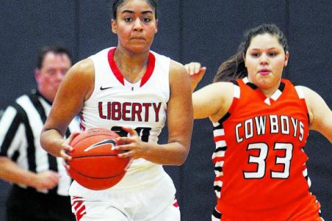 Liberty’s Paris Strawther (30) brings the ball down court while being guarded by Chapa ...