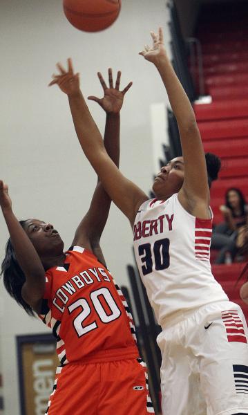 Liberty’s Paris Strawther (30) reaches high for the ball over Chaparral’s Marcia ...