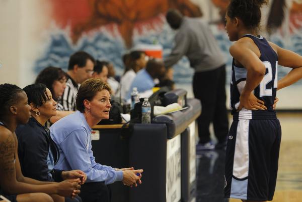Centennial girls basketball coach Karen Weitz offers some individual instruction to one of t ...