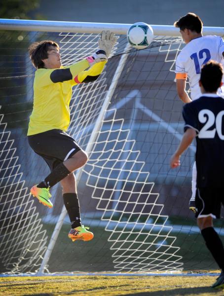 Palo Verde High School goalkeeper Nishesh Yadav saves a header by Sierra Vista’s Isaac ...