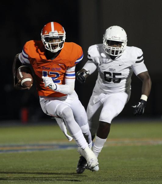 Bishop Gorman quarterback Randall Cunningham (12) runs past Crespi’s Matthew Orozco on ...