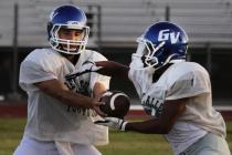 Green Valley quarterback Christian Lopez hands the ball off during practice. Lopez and the G ...