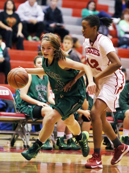 Green Valley freshman Brooke Haney, left, drives the ball past Arbor View junior Ariona Gill ...