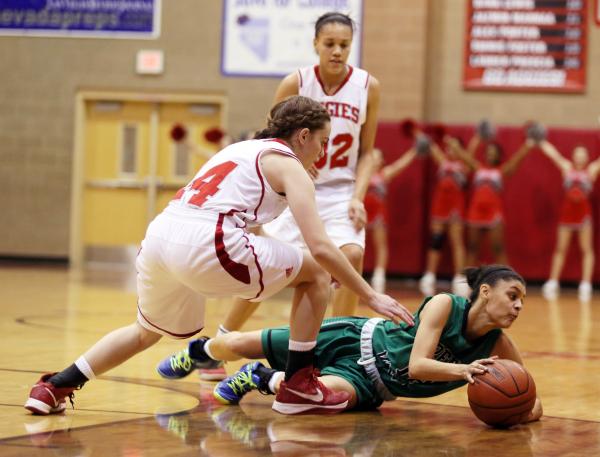 Arbor View senior Dani Chaney, left, and Green Valley senior Alexxus Johnson go after a loos ...