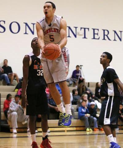 Findlay Prep’s Dillon Brooks (5) goes up for a shot between PHASE 1 Academy’s Ke ...
