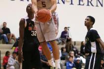 Findlay Prep’s Dillon Brooks (5) goes up for a shot between PHASE 1 Academy’s Ke ...