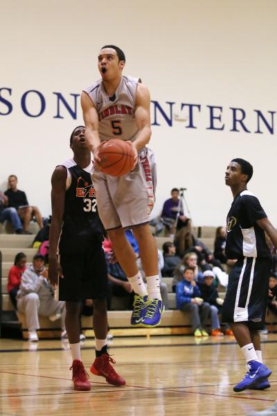 Findlay Prep’s Dillon Brooks (5) goes up for a shot between PHASE 1 Academy’s Ke ...