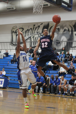 Coronado’s Justice Augmon attempts a shot as Basic’s Jaylen Rose defends during ...