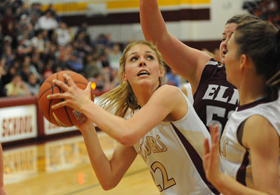Faith Lutheran High School girls basketball player, Taylor Hammer, center, goes up for a sho ...