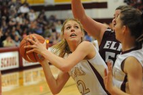 Faith Lutheran High School girls basketball player, Taylor Hammer, center, goes up for a sho ...