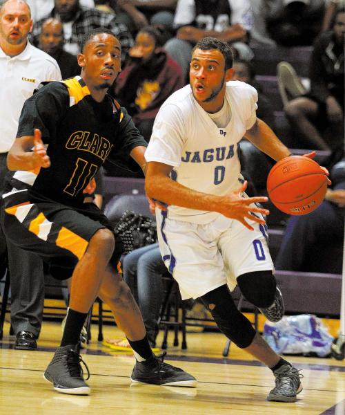 Desert Pines’ Julian Jacobs tries to move past Clark’s Sir Washington during the ...
