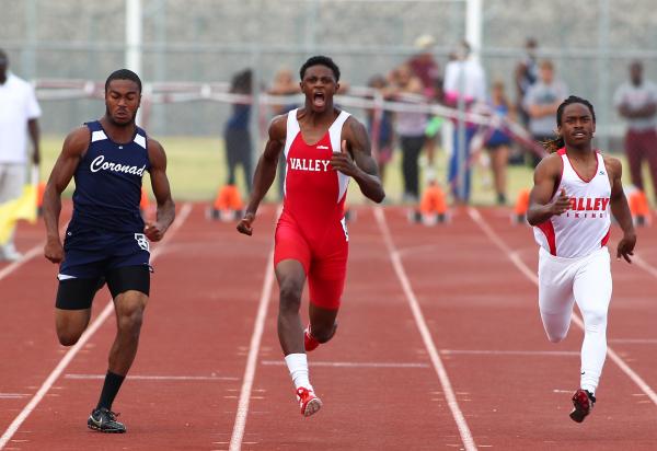 Valley’s Arphaxad Carroll, center, sets the paced in the 100-meter dash Friday during ...