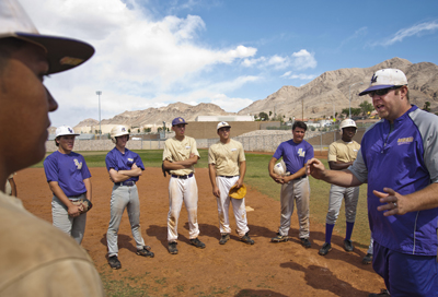 Sunrise Mountain High School varsity baseball head coach Shawn Dickson, right, speaks to his ...