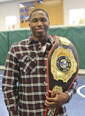 Spring Valley High School senior Ray Waters poses with one of his trophy belts in the wrestl ...