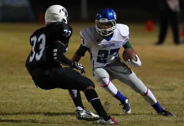 Green Valley’s Markus Varner looks to get past Canyon Springs’ Christian Minor o ...